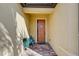 Inviting front entry with terracotta tile flooring and a charming, light brown door at 13848 Rinuccio St, Venice, FL 34293