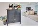 Black cabinet with decorative items, situated near the living room at 13848 Rinuccio St, Venice, FL 34293