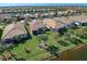 Aerial view of houses with backyard access to a canal at 13848 Rinuccio St, Venice, FL 34293