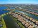 Aerial view of home community, featuring water, landscaping, and houses at 13848 Rinuccio St, Venice, FL 34293