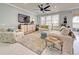 Spacious living room with comfy sofas, large TV, and ceiling fan at 13848 Rinuccio St, Venice, FL 34293