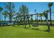 Wooden swing set and tire swings in a park setting at 13848 Rinuccio St, Venice, FL 34293