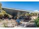 Casual outdoor dining area with picnic tables, covered seating, and easy beach access under a large canopy at 147 Tampa E Ave # 202, Venice, FL 34285