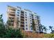 Stunning multi-story condo building with balconies, stucco siding, and lush landscaping offering a luxurious coastal lifestyle at 147 Tampa E Ave # 202, Venice, FL 34285