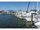 Scenic marina with sailboats and yachts docked on a calm, clear day with a building in the background at 147 Tampa E Ave # 202, Venice, FL 34285