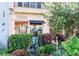 Shopping area with a statue surrounded by lush greenery and flower beds at 147 Tampa E Ave # 202, Venice, FL 34285