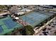 Aerial view of multiple tennis courts in a sunny community with parking and landscaping at 147 Tampa E Ave # 202, Venice, FL 34285