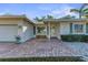 Front entrance of the home with brick pavers and landscaping at 1507 N Knollwood Dr, Bradenton, FL 34208