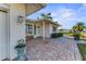 Side view of the home's entrance, with brick pavers and landscaping at 1507 N Knollwood Dr, Bradenton, FL 34208