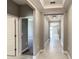 Bright hallway with neutral paint and tile floors, leading to other rooms at 16851 Terrapin Key Dr, Port Charlotte, FL 33953