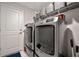 Laundry room with washer, dryer, and shelving at 18439 Elgin Ave, Port Charlotte, FL 33948