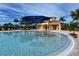 Community pool with umbrellas and a nearby clubhouse at 19177 Corradino Blvd, Venice, FL 34293