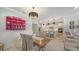 Bright dining area with a wooden table, kitchen view, and pink shelving at 19177 Corradino Blvd, Venice, FL 34293