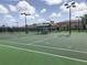 Well-maintained tennis courts with seating area at 20190 Ragazza Cir # 202, Venice, FL 34293