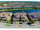 Stunning aerial view of a waterfront community featuring well-maintained townhomes, lush landscaping, and serene lake views at 20190 Ragazza Cir # 202, Venice, FL 34293