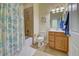 Bathroom featuring a shower with nautical themed curtain, vanity, and decorative ship's wheel at 20190 Ragazza Cir # 202, Venice, FL 34293