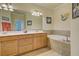 Bathroom with double vanity, soaking tub, and decorative accents offers a relaxing retreat at 20190 Ragazza Cir # 202, Venice, FL 34293