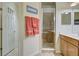 Bright bathroom featuring a glass-enclosed shower, a tiled floor, and a towel rack at 20190 Ragazza Cir # 202, Venice, FL 34293