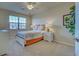Sunlit bedroom with a ceiling fan, a window, and a neutral color scheme promoting relaxation at 20190 Ragazza Cir # 202, Venice, FL 34293