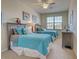 Comfortable bedroom featuring two beds, ceiling fan, and a window for natural light at 20190 Ragazza Cir # 202, Venice, FL 34293