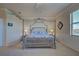 A serene bedroom featuring a four-poster bed, soft lighting, and neutral decor for a calm retreat at 20190 Ragazza Cir # 202, Venice, FL 34293