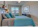 Comfortable bedroom featuring two beds, ceiling fan, and a window for natural light at 20190 Ragazza Cir # 202, Venice, FL 34293