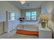 Comfortable bedroom featuring a ceiling fan, white dresser, and a window for natural light at 20190 Ragazza Cir # 202, Venice, FL 34293