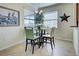 Eat-in kitchen area featuring tile floors, a round table, and windows for natural light and casual dining at 20190 Ragazza Cir # 202, Venice, FL 34293