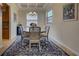 Cozy dining area with a round table, seating for six, and view into the kitchen area at 20190 Ragazza Cir # 202, Venice, FL 34293
