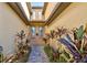 Inviting entrance showcasing a brick walkway, lovely tropical plants, and a pair of double glass doors at 20190 Ragazza Cir # 202, Venice, FL 34293