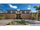 Beautiful townhome exterior featuring a two-car garage, brick driveway, desert landscaping, and neutral color palette at 20190 Ragazza Cir # 202, Venice, FL 34293