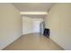Garage featuring an entrance door, hot water heater and plenty of space for storage at 20190 Ragazza Cir # 202, Venice, FL 34293