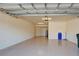 Large garage featuring an overhead garage door, epoxy flooring, and additional storage space at 20190 Ragazza Cir # 202, Venice, FL 34293