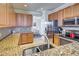 Functional kitchen featuring granite counters, stainless appliances, and ample counter space at 20190 Ragazza Cir # 202, Venice, FL 34293