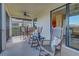 Covered lanai with cozy seating and lake views, an ideal spot for relaxation and outdoor dining at 20190 Ragazza Cir # 202, Venice, FL 34293