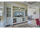 Spacious living room with built-in cabinetry, decorative rug, and open access to dining area at 20190 Ragazza Cir # 202, Venice, FL 34293
