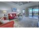 Bright and airy living room with comfortable seating, a stylish area rug, and access to the screened lanai at 20190 Ragazza Cir # 202, Venice, FL 34293