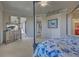 Spacious primary bedroom featuring a canopy bed, a TV, and access to a screened in lanai at 20190 Ragazza Cir # 202, Venice, FL 34293