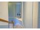 Elegant carpeted staircase with wood railing, complemented by stylish wall decor and soothing blue accents at 20190 Ragazza Cir # 202, Venice, FL 34293