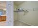 Carpeted walk-in closet with wire shelving offers optimal storage solutions for an organized home at 20190 Ragazza Cir # 202, Venice, FL 34293