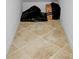 Small basement storage area with beige tile flooring at 20391 Lagente Cir, Venice, FL 34293