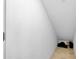 Unfinished basement storage area with white walls and beige tile flooring at 20391 Lagente Cir, Venice, FL 34293