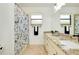 Bathroom with double vanity, granite countertop, and shower/tub combo at 20391 Lagente Cir, Venice, FL 34293