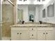 Bathroom with double vanity, granite countertop, and walk-in shower at 20391 Lagente Cir, Venice, FL 34293