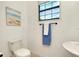 Clean bathroom with toilet, sink, and towel rack at 20391 Lagente Cir, Venice, FL 34293