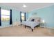 Spacious bedroom with light blue walls, carpeted floor, and large windows at 20391 Lagente Cir, Venice, FL 34293