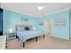 Spacious bedroom with light blue walls, carpeted floor, and large windows at 20391 Lagente Cir, Venice, FL 34293