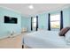 Spacious bedroom with light blue walls, carpeted floor, and large windows at 20391 Lagente Cir, Venice, FL 34293