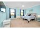 Spacious bedroom with light blue walls, carpeted floor, and large windows at 20391 Lagente Cir, Venice, FL 34293