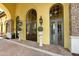 Elegant community entrance with arched doorways and landscaping at 20391 Lagente Cir, Venice, FL 34293